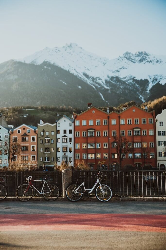 Charming cityscape of Innsbruck with colorful buildings and snow-capped mountains.